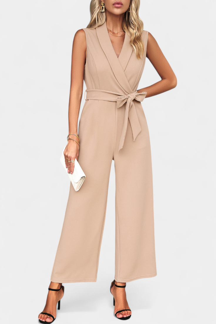 Woman wearing a cross-back wide-leg jumpsuit with an adjustable knot waist
